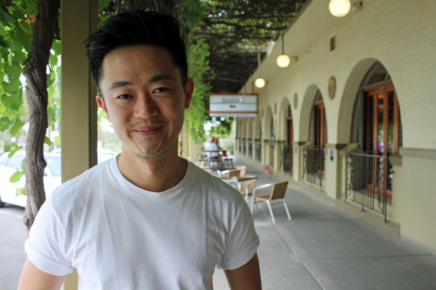 Man in white t shirt looking at camera