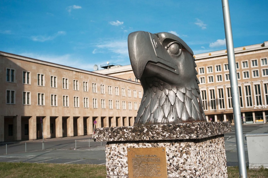 At the entrance of Tempelhof Airport, the head of a Nazi eagle greets today’s visitors