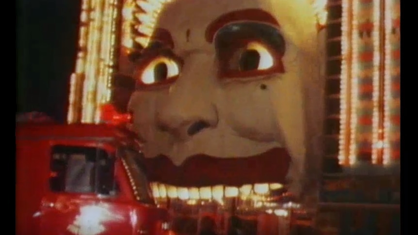 a fire engine in front of a big clown face