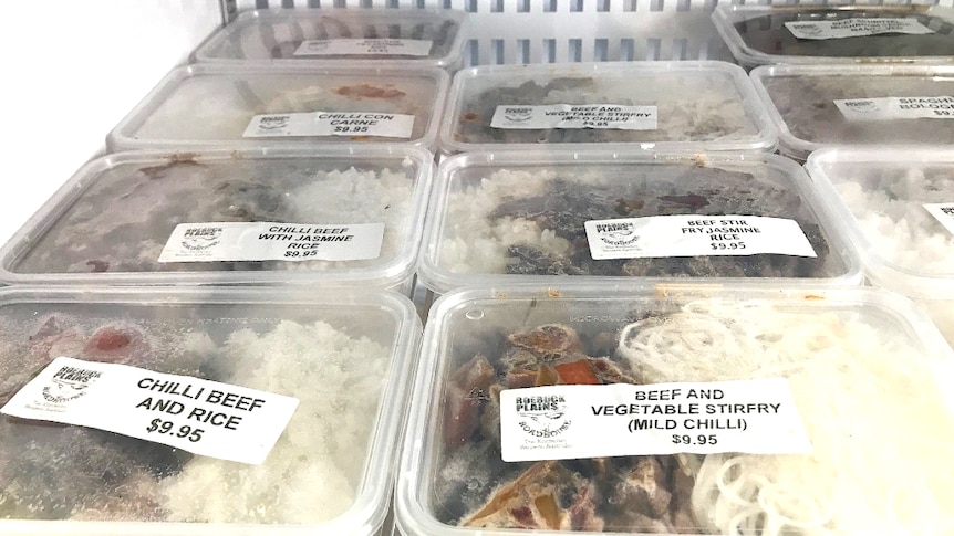 Plastic containers of meat and rice at an outback Australian roadhouse.