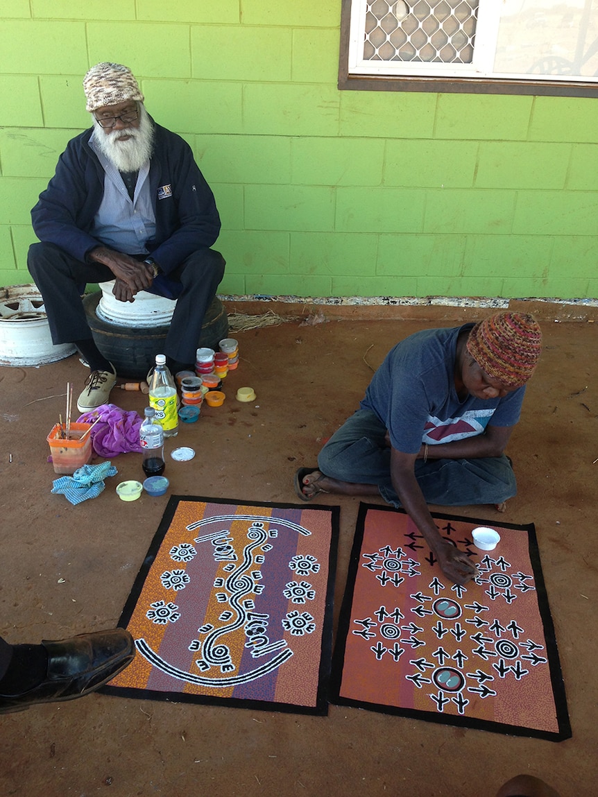 Rex Granites looks on as his cultural sister paints their eagle dreaming site