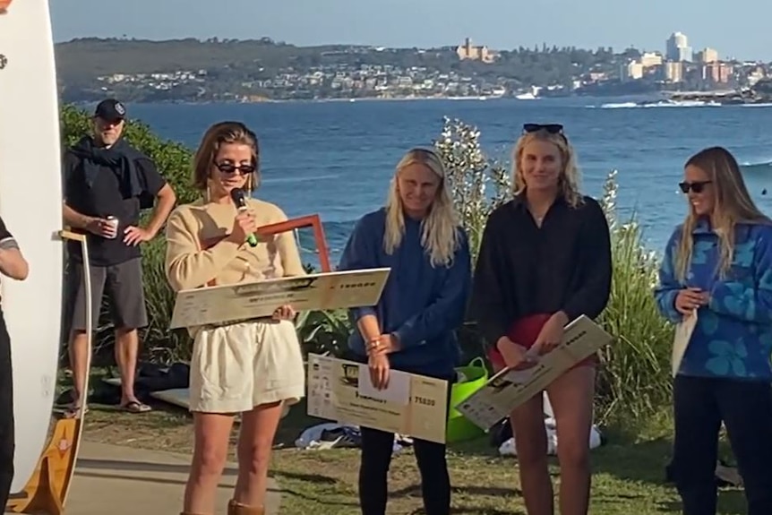 female surfer accepts cash prize,
