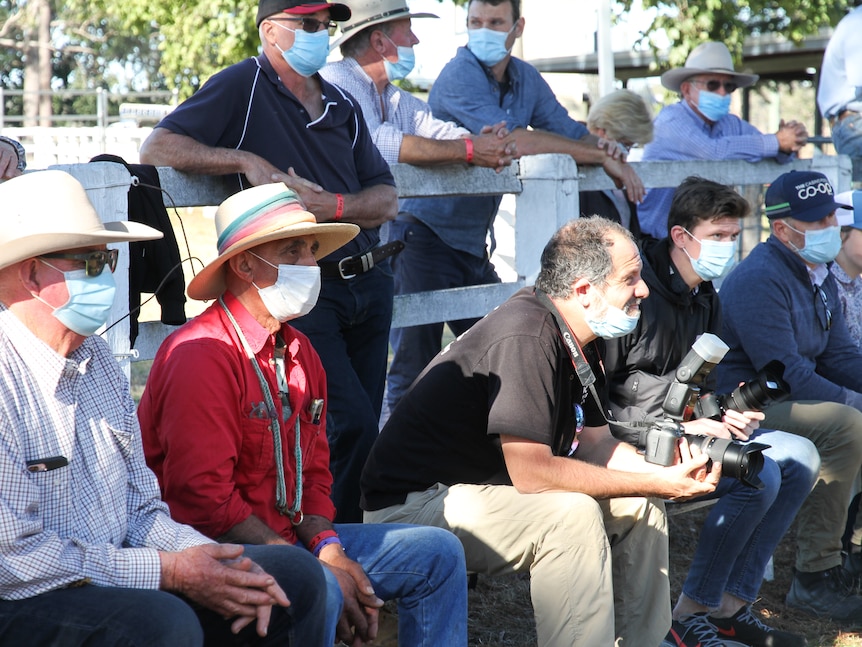 Dog triallers, spectators and photographers wearing masks during the award presentation.