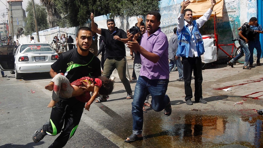 Man runs with child after Gaza air strike