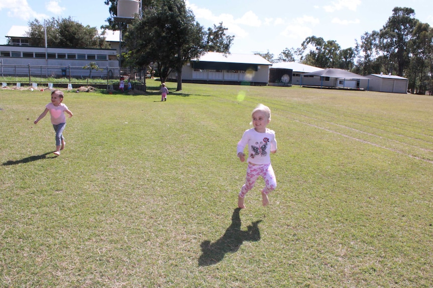 Preschooler in a running race on a school oval.