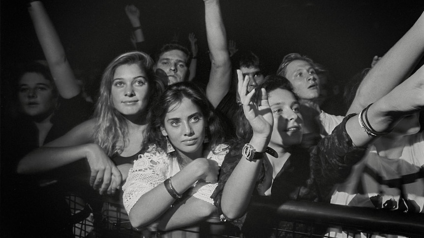 A black and white image of a crowd with a teenage Natalie in the front, looking up at the stage