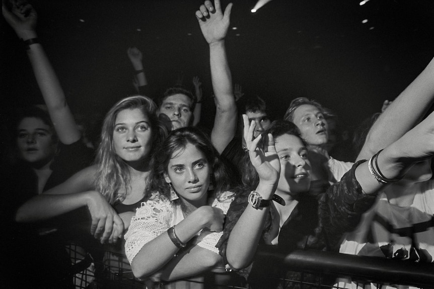 A black and white image of a crowd with a teenage Natalie in the front, looking up at the stage