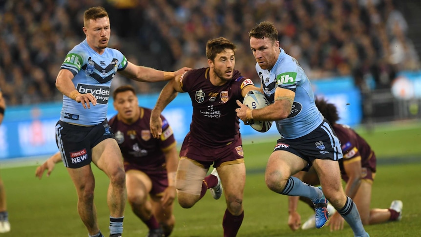 James Maloney, for the Blues, runs away from the Maroons' Ben Hunt.