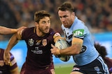James Maloney, for the Blues, runs away from the Maroons' Ben Hunt.