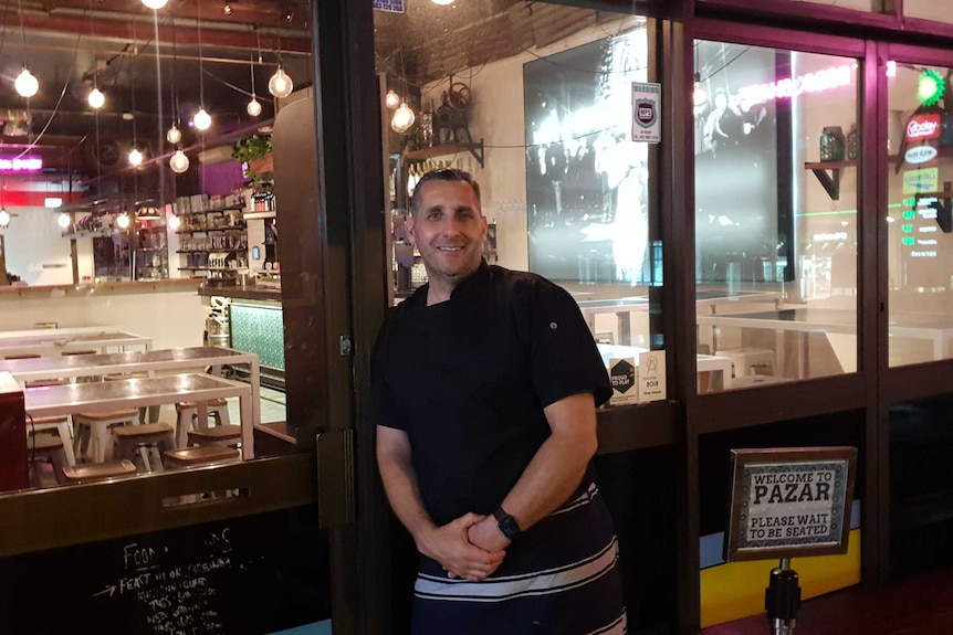 Attila Yilmaz standing outside his restaurant, Pazar