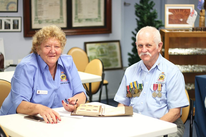 Gillian Lindsay and Geoff Whittet, wearing medals on his shirt, sit at a table at the Boonah RSL.