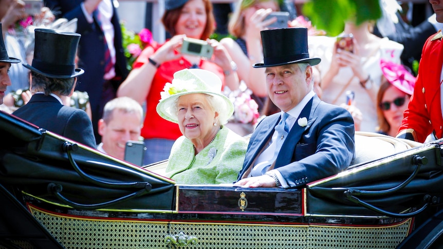 The Queen and Prince Andrew sitting in a horse drawn carriage, smiling 