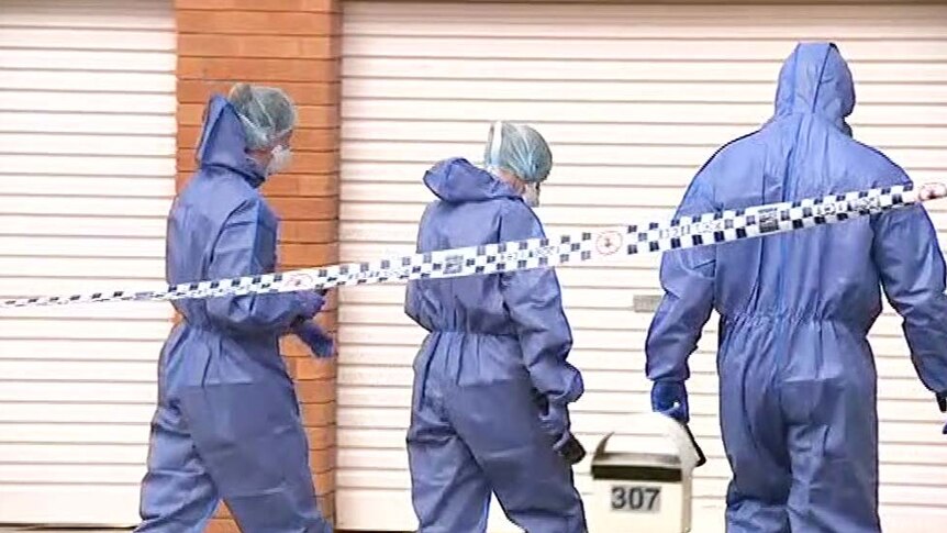 Forensic officers outside a house in Rockhampton where a woman body was found in suspicious circumstances.