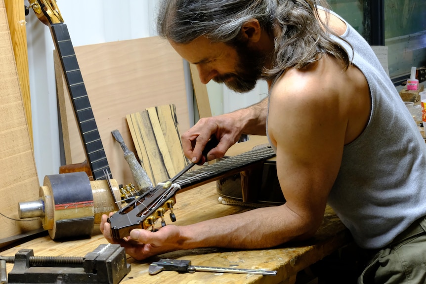 He builds a guitar in his workshop