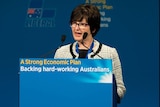 A lady with short dark hair speaking at a Liberal Party lectern