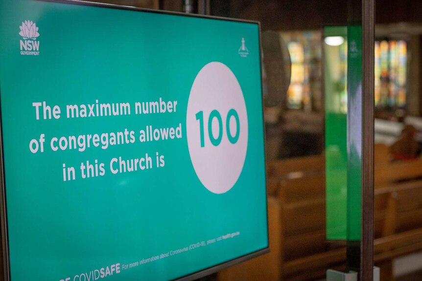 A sign showing the maximum number of congregants is 100