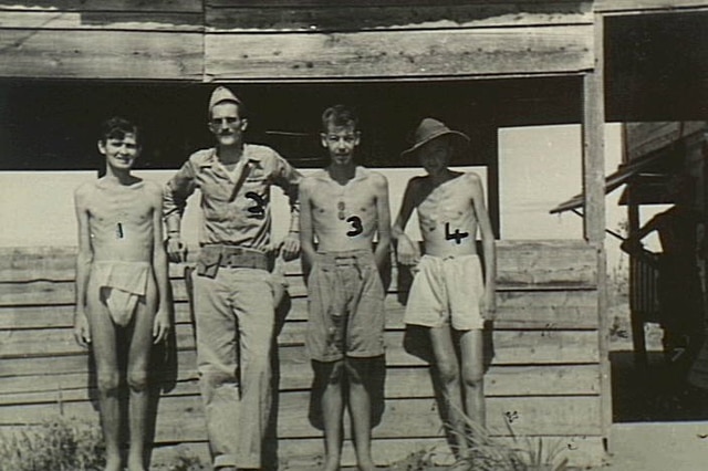 US Captain L Woods with Australian prisoners of war