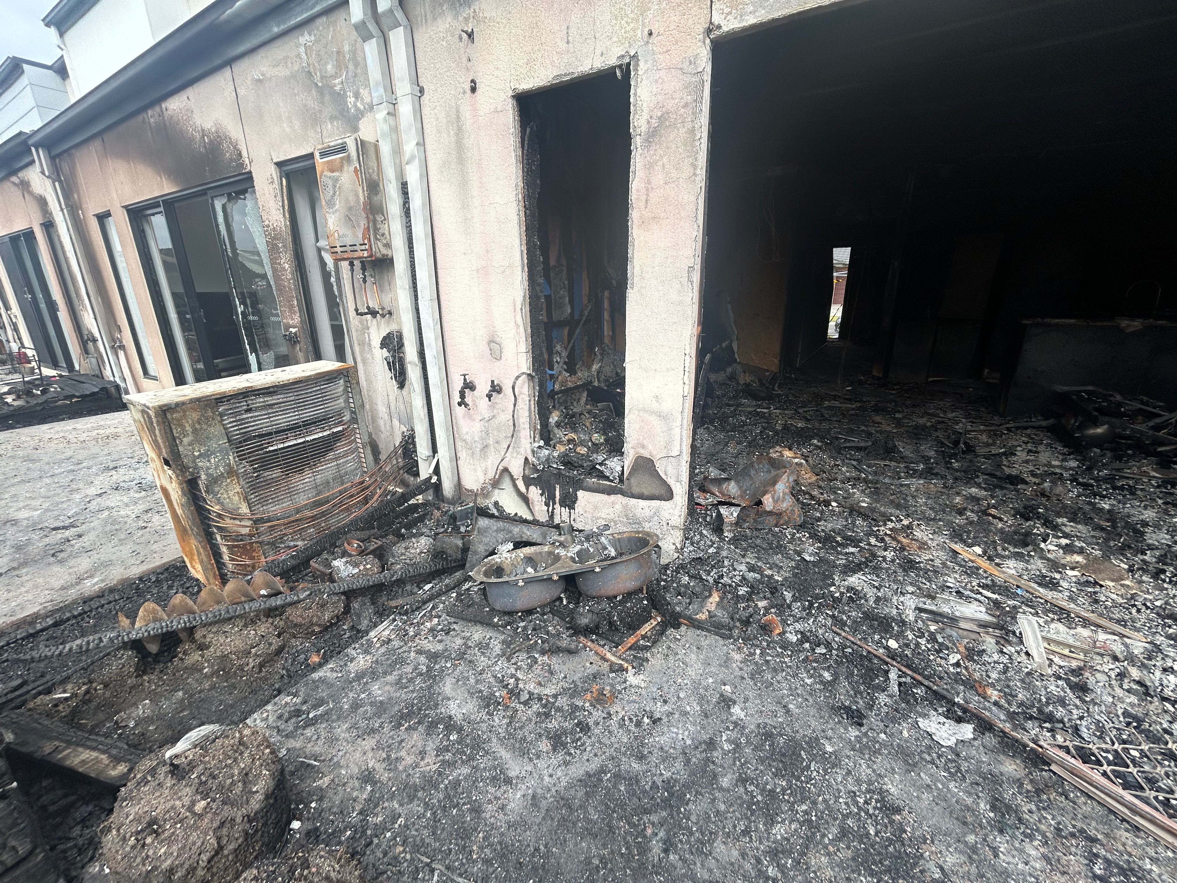 The inside of a house completely destroyed by fire, ash and damage to building exterior