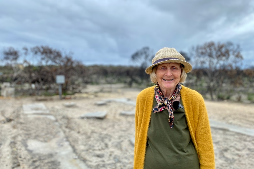 woman standing on burnt lot