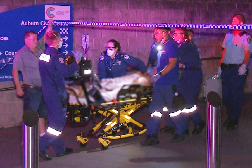 A person on a stretcher with paramedics