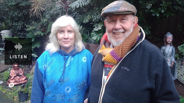 two people, smiling at the camera, standing in their garden. Has Audio.