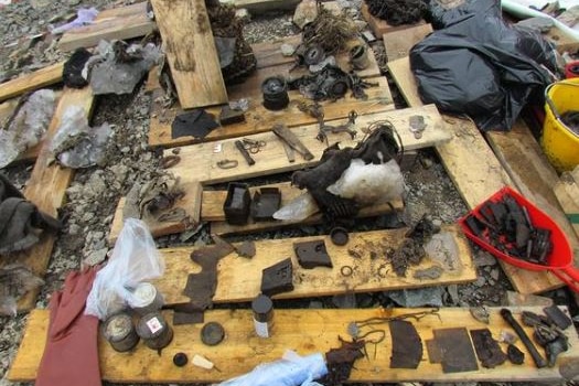 Antique items are seen spread out on the ground 