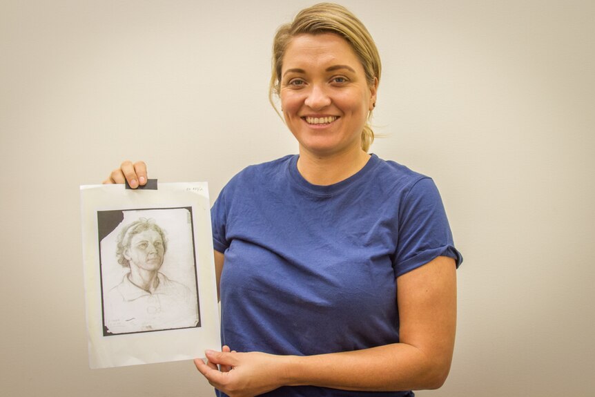 Alethea Beetson with the drawing of her grandmother.
