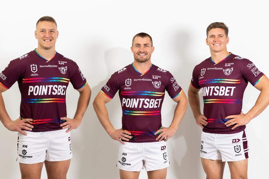 Three Manly NRL players wear shirts with rainbow trim