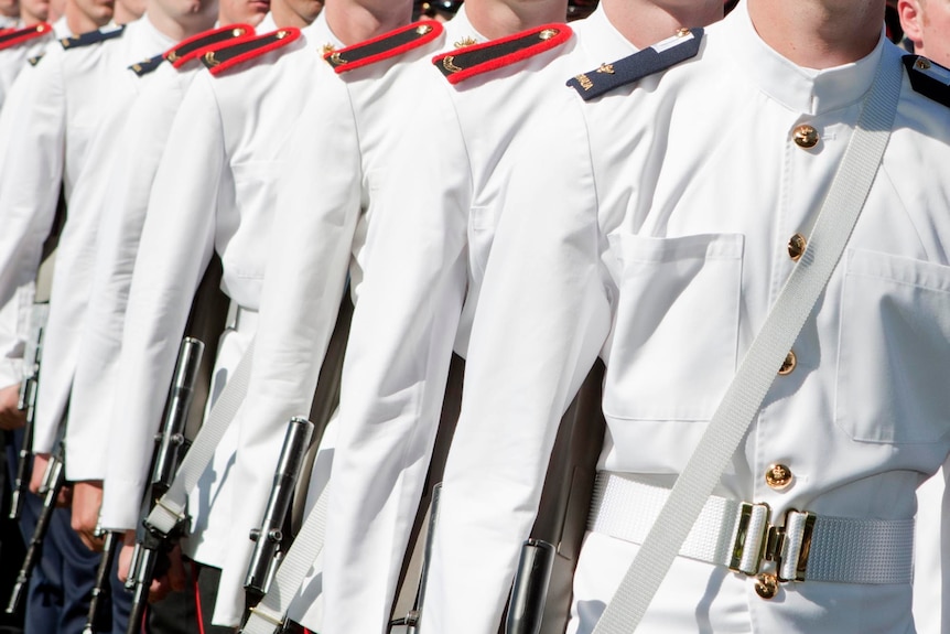 Officer cadets in uniform standing side-by-side
