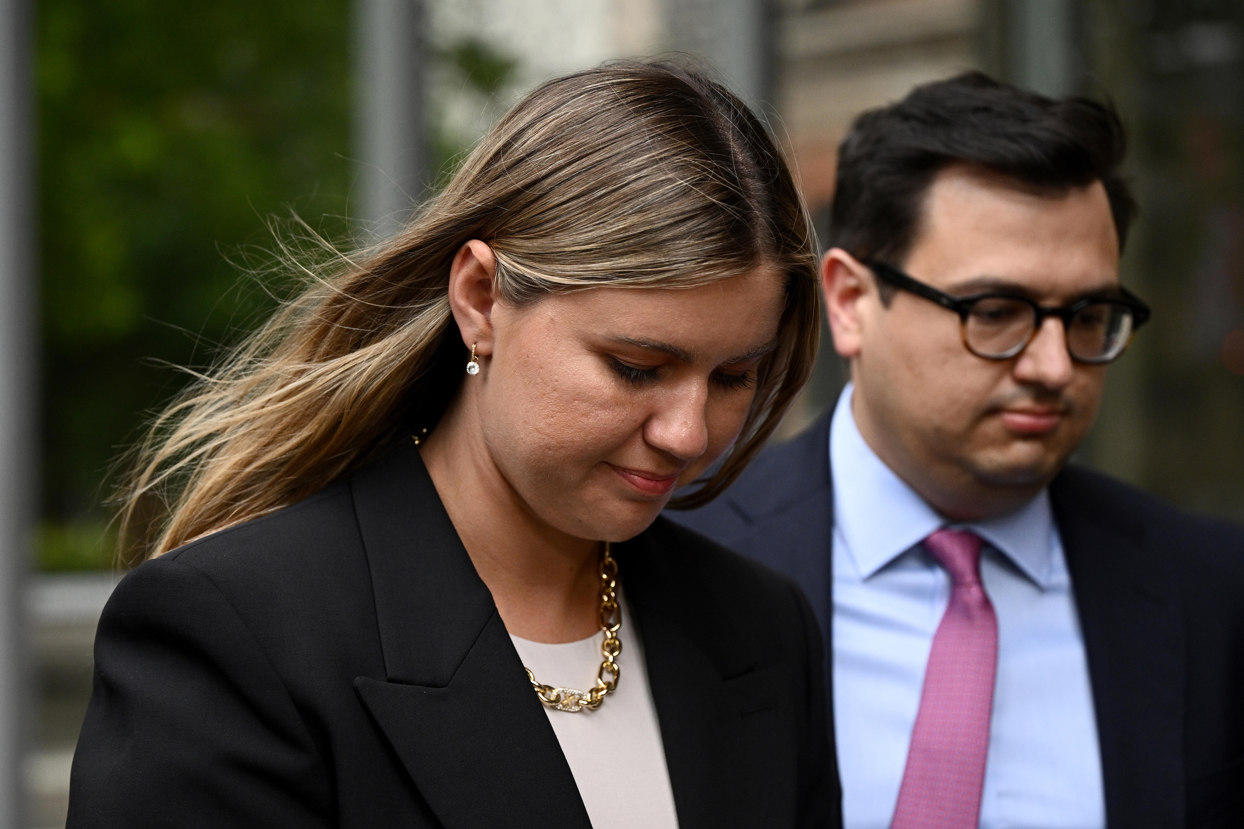 Brittany Higgins walks with her partner.