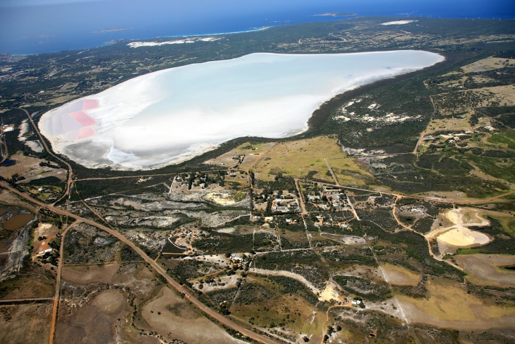 An aerial photograph of Pink Lake, which is blue apart from some pink evaporation ponds