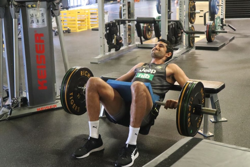 Two men train in an indoor gym