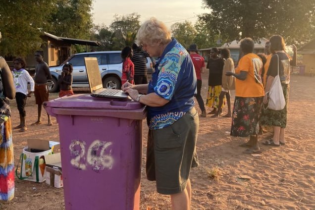 A Miwatj Health worker works on her laptop in Milingimbi