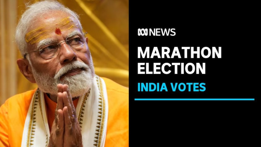 Marathon Election, India Votes: Narendra Modi looks off-camera with his palms together.