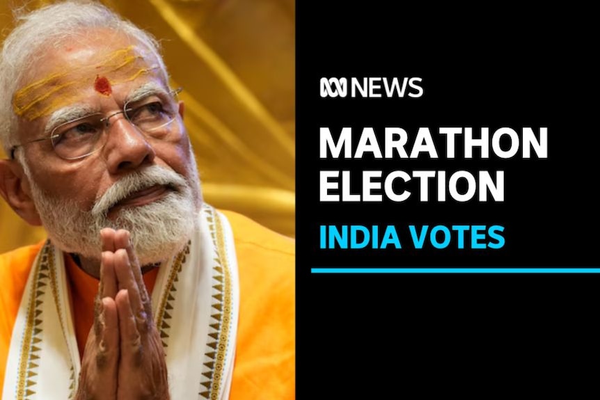 Marathon Election, India Votes: Narendra Modi looks off-camera with his palms together.