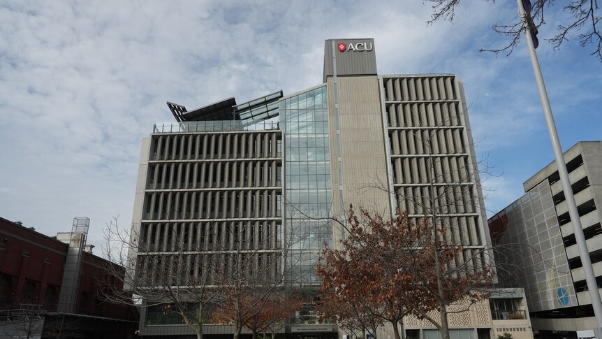 A wide shot of a multi-storey university building with the ACU logo.