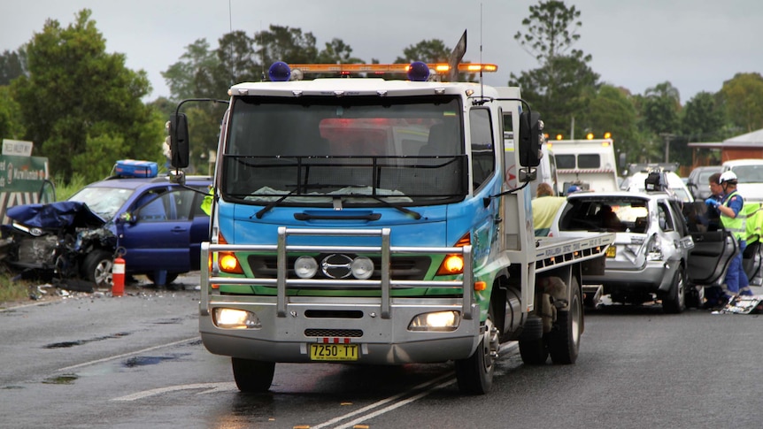 Emergency services personnel tend to an accident on Tweed Valley Way at Tumbulgum.