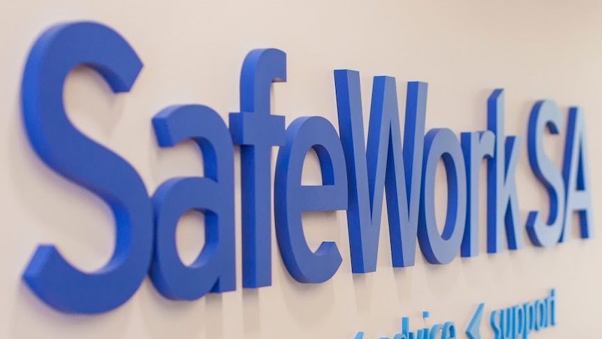 SafeWork SA sign on a wall.