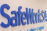 SafeWork SA sign on a wall.