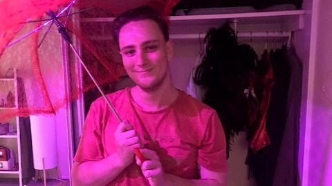 Sex worker Renon Schafer holding a red lace umbrella.