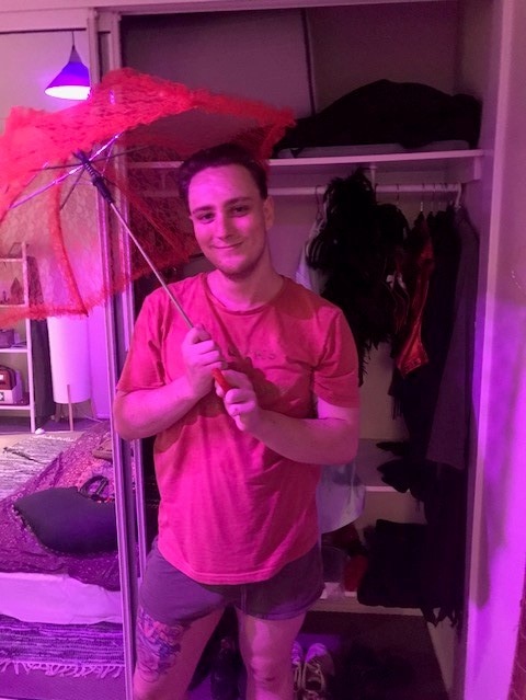 Sex worker Renon Schafer holding a red lace umbrella.