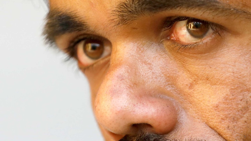 A close up photo of a Pakistani man with a beard