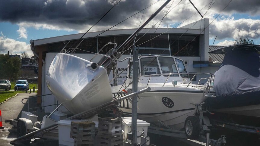 A yacht blown onto its side.