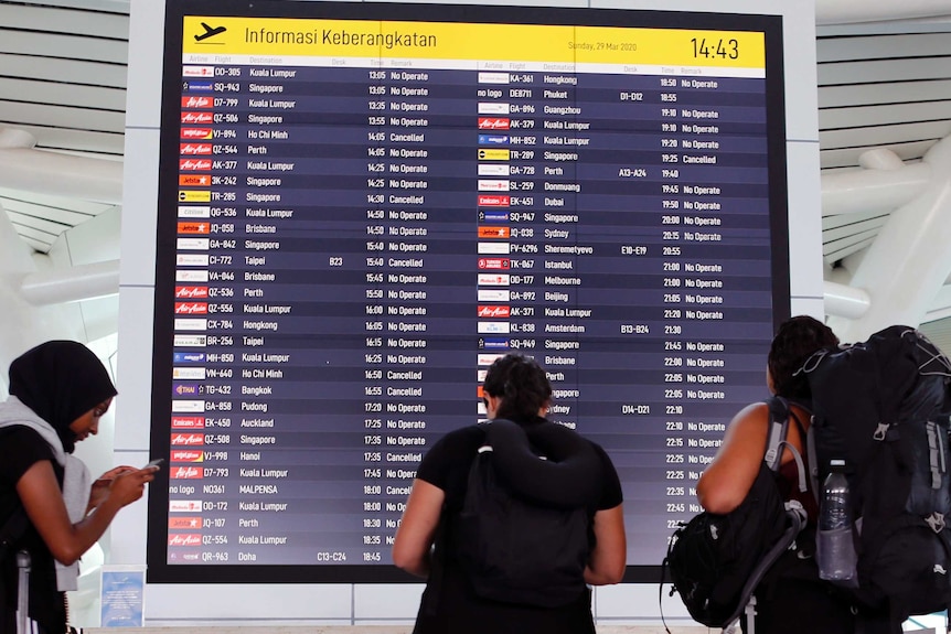 Foreign tourists check their flight information at Bali's International Airport and almost all flights are no longer operating.