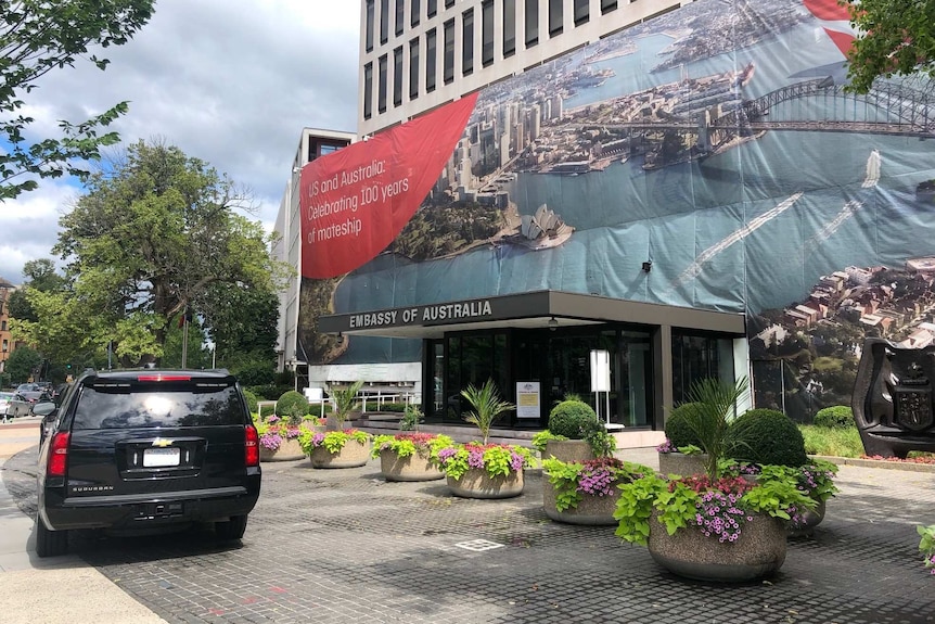 A black Chevy Suburban is parked out the front of the Australian Embassy in Washington DC