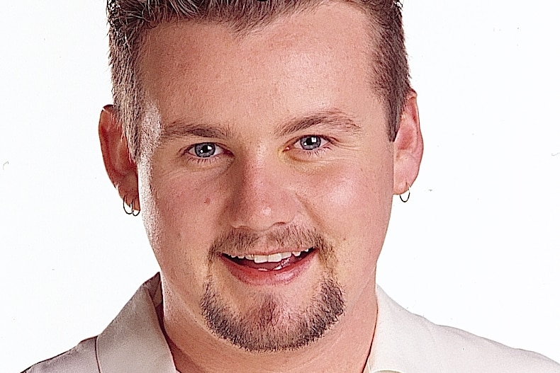 A professional headshot of actor Ryan Moloney.