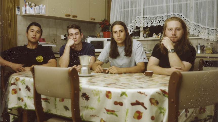A 2018 press shot of Slowly Slowly seated at a kitchen table