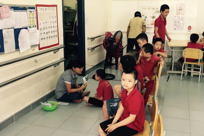 Children with disabilities blamed on Agent Orange sitting on chairs inside a class room at the day care centre in Vietnam.