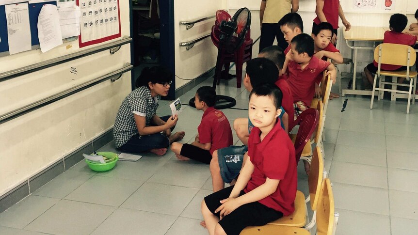 Children with disabilities blamed on Agent Orange sitting on chairs inside a class room at the day care centre in Vietnam.