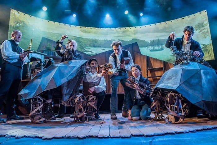 Cast on stage with puppets.